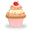 Colorful cupcake with swirled frosting, sprinkles, and cherry on top in pink striped wrapper