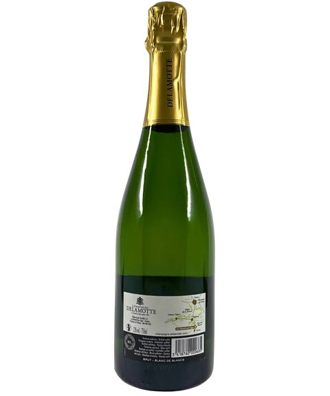 Back label of Delamotte Blanc de Blancs Brut Champagne NV â French sparkling wine with vineyard map, producer details, and gold foil