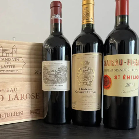 Premium Bordeaux wine collection featuring 2019 Château Lafite Rothschild Pauillac, 2015 Château Gruaud Larose St-Julien, and 2016 Château Figeac Premier Grand Cru Classé St-Émilion red wine bottles with wooden wine crates