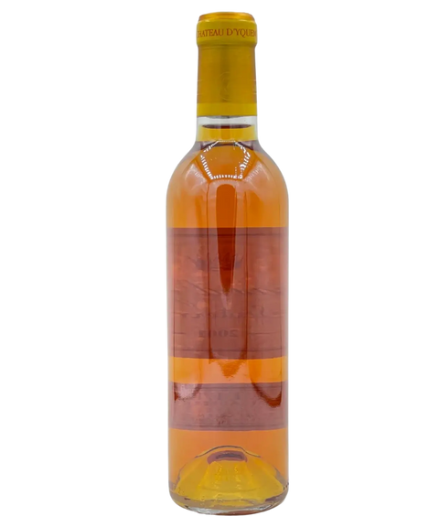 Château d'Yquem Sauternes sweet dessert wine bottle with deep golden amber color and gold foil capsule from Bordeaux France