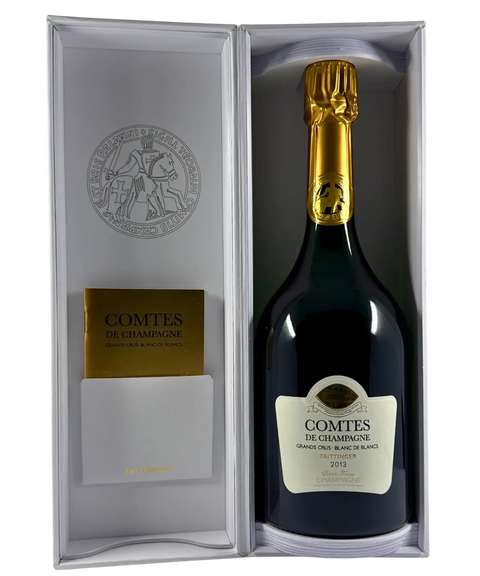 Open presentation box displaying Taittinger Comtes de Champagne Grand Cru Blanc de Blancs 2013 bottle, luxury Champagne gift set.